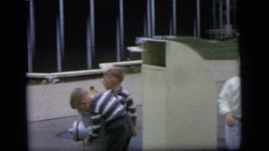 1964: women, men, and children are waiting on the road side CAMDEN NEW JERSEY