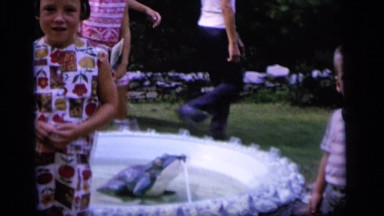 1964: children stand around a fountain in a backyard idly CAMDEN NEW JERSEY