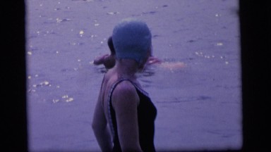1964: men, women, and children swimming in a lake wearing bathing suits. CAMDEN
