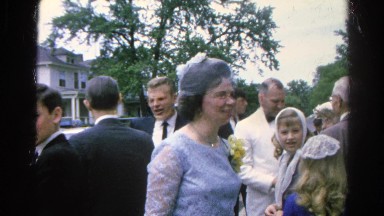 1966: woman dressed nicely, and in good spirits, speaking to others