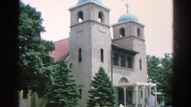 1966: car with balloons driving my a church DANVILLE, ILLINOIS