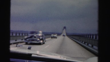 1955: driving across long bridge over lake waters MIAMI, FLORIDA