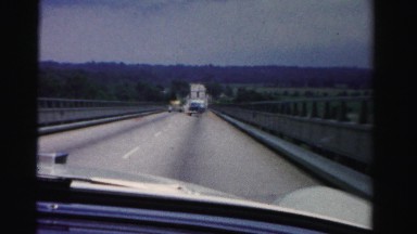 1955: classic 50's car passes on highway driving fast windshield view MIAMI