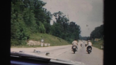 1955: driving windshield view motorcycles ride in tandem MIAMI, FLORIDA