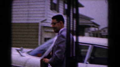 1961: man carrying purse follows lady into house from the car parked nearby