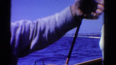 1958: Old Man with Fish Catch on Boat in Minnesota