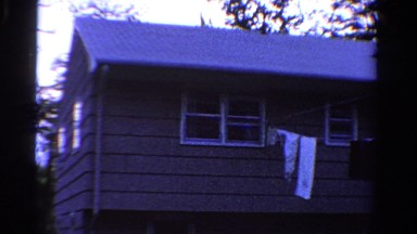 1958: clothing on clothes line with house in the background MINNESOTA