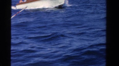 1958: family takes ride on the ocean water when they are on boat they own.