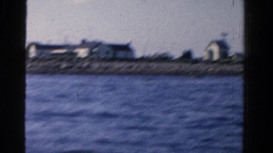 1958: man in motorboat on lake on sunny day fishing MINNESOTA
