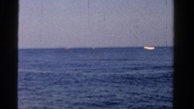 1958: middle aged man fishing boat bright blue sunny day MINNESOTA