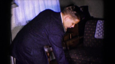 1961: Child Opening Christmas Presents Under Tree in Hagerstown, Maryland