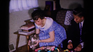 1961: blue polka dot dress girl rubs family cat on face HAGERSTOWN, MARYLAND