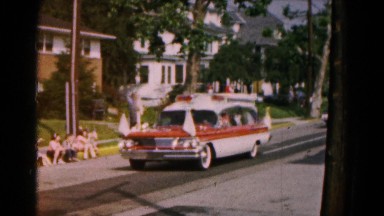 1961: parade led by official vehicle promenades down the neighborhood street