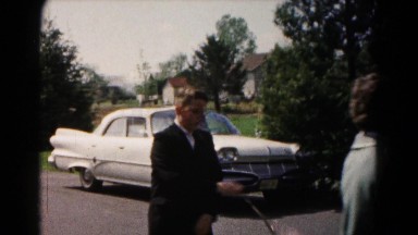 1961: young boy in suit swinging woman's purse HAGERSTOWN, MARYLAND