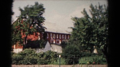 1961: large red barn and out building with windmill nearby