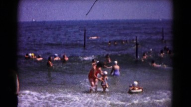 1961: mom and kids playing in the surf HAGERSTOWN, MARYLAND