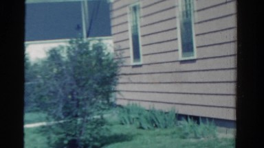 1958: view of suburban home and woman MINNESOTA