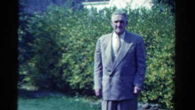1958: an old man in formal suit standing on the lawn of the garden MINNESOTA