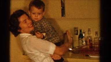 1958: mom talking to her son while holding him close MINNESOTA