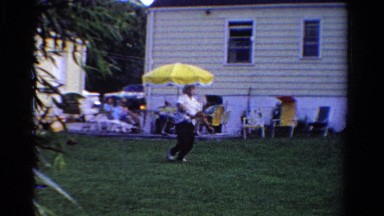 1958: heavyset man in hat in the yard playing badminton MINNESOTA
