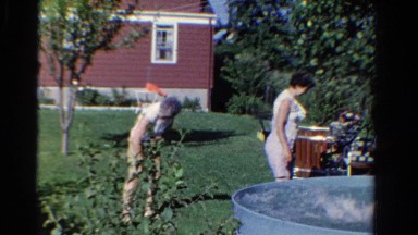 1958: kids playing in backyard pool innocently splash grandmother lightheartedly