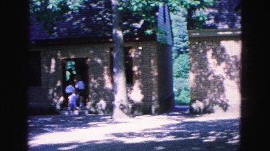 1964: groups of well dressed people walking into brick buildings