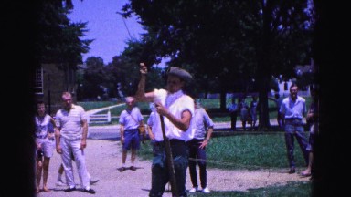 1964: guy in white priming rifle WILLIAMSBURG