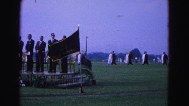 1964: creepy cult like ceremony adult men standing on podium marching background