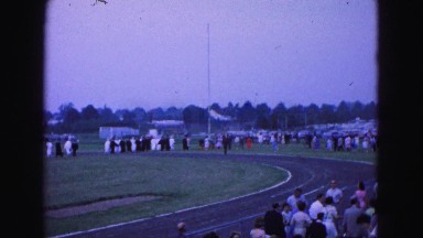 1964: large area with lot people moving en masse beside road WILLIAMSBURG