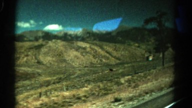 1967: journey through barren land with small hills under the blue sky COLORADO