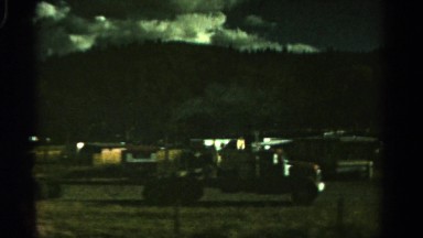 1967: driving past field full of old vehicles with the mountains