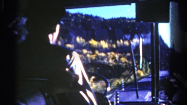1967: driver traveling along country road passing some hills along the way