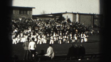 1946: marching band high school football game kickoff in regal stadium