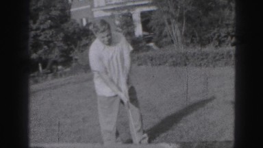 1946: man is seen beside garden playing HARRISBURG