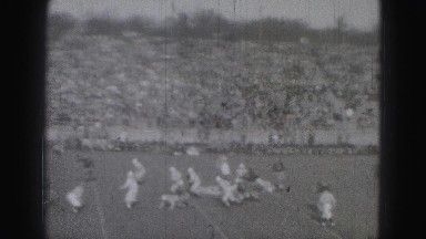 1946: exciting football play man gets touchdown crowd fans jump up