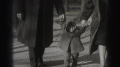 1946: small child holding parent's hands while walking between them HARRISBURG