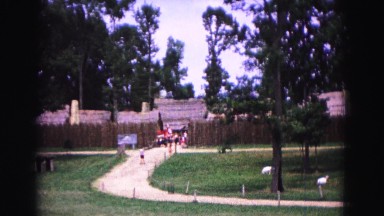 1964: organized marching band coming through the gate down the hill.