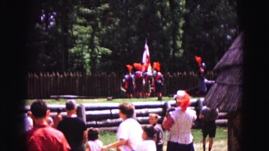1964: marching at summer camp with flags and many admiring onlookers watching
