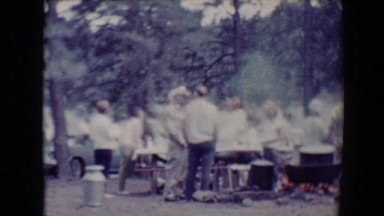 1967: large group of people gathered in park, cooking and listening to music