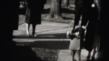 1946: Small Child Takes First Unsure Steps by Parent's Hand