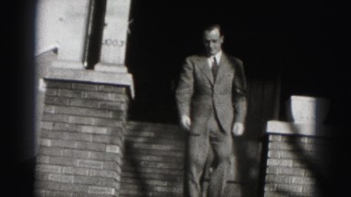 1946: Well-Dressed Man Smiles as He Exits Home in Harrisburg