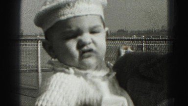 1946: mother kissing confident baby boy