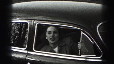 1946: woman is smiling and talking from the car HARRISBURG