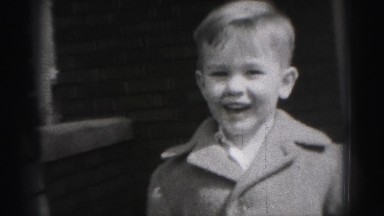 1946: cute young boy standing outdoor in front of brick home HARRISBURG