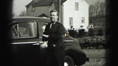 1946: father arriving home stops to open the hood of the car and check the belt
