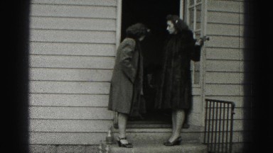 1946: two women in long coats exiting house with toddler HARRISBURG