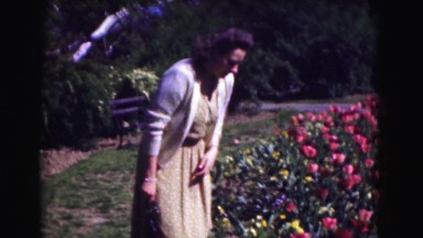 1946: happy woman flowers skirt park bench day girls picnic breeze trees