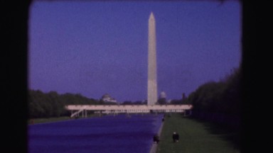1946: people stand in the grass in front of the reflecting pool