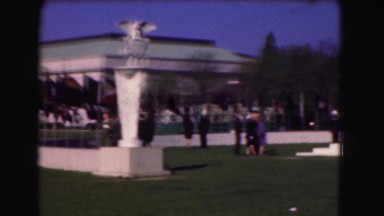 1946: people gathered at military memorial event on windy day walking