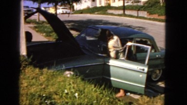 1963: lady cleans up the car leaving the bonnet open CALIFORNIA